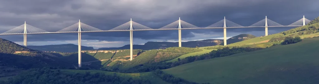 Vue panoramique du viaduc de Millau franchissant la vallée du Tarn au milieu des collines.